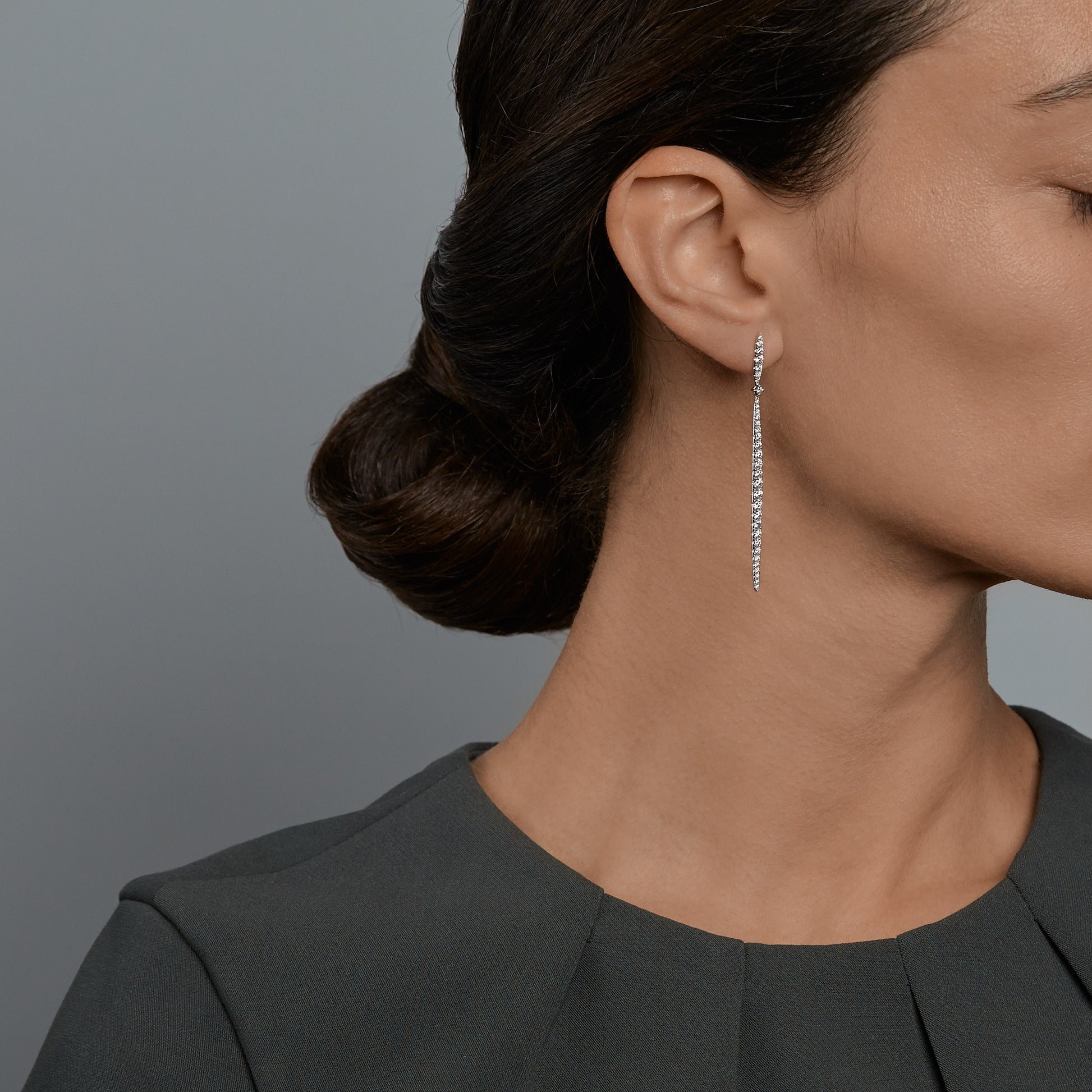 Woman wearing the Oliver Heemeyer Sword diamond earrings.
